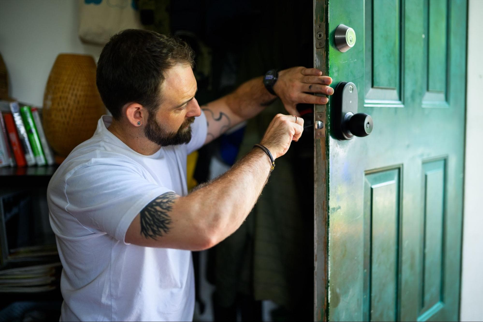 Powell’s Doors & Windows adjusting door hardware during a repair in Portland